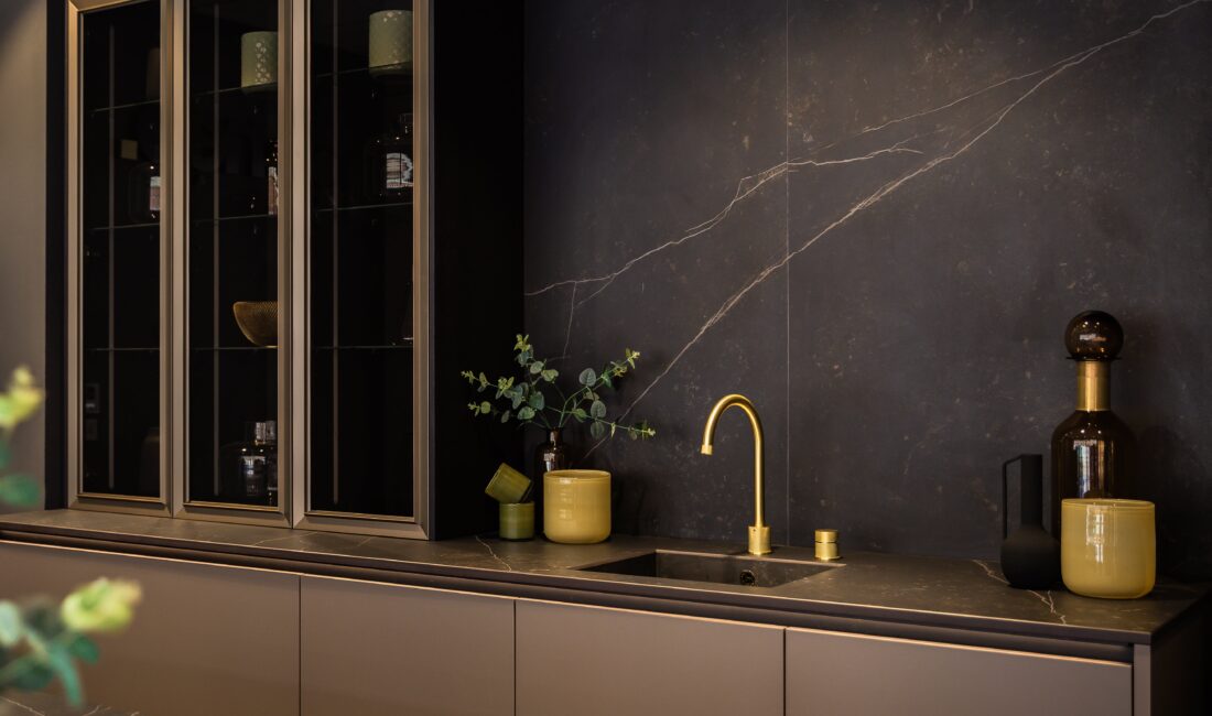 neoLODGE kitchen in Blackened Oak with gold tap and glass showcase cabinets